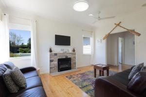 a living room with a couch and a fireplace at Mary Grant in Port Fairy