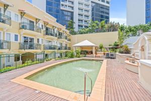 a swimming pool in the middle of a building at Stylish CBD retreat - 8 Il Palazzo in Cairns