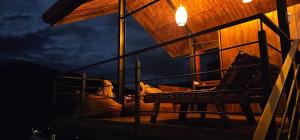 a man sitting in a horse stable at night at Ella Mount View Guest Inn in Ella