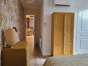 a bedroom with a bed and a yellow door at Chambres d'hôtes avec piscine, cuisine et jardin à Messas - FR-1-590-488 in Messas +12 photos