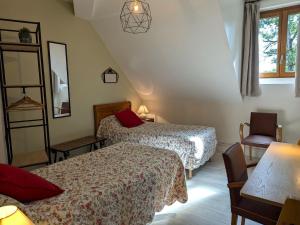 a hotel room with two beds and a chair at Chambre familiale avec Wi-Fi inclus, petit-déjeuner et espace convivial - FR-1-590-473 in Ligny-le-Ribault