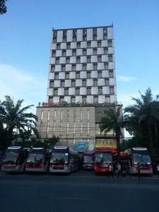 a group of buses parked in front of a building at Beijing Hotel Vinh - by BAY LUXURY in Ngô Xa