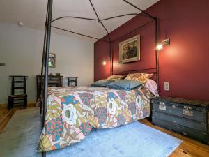 a bedroom with a canopy bed and a blue rug at Ferme de charme avec piscine et tennis privés - FR-1-582-496 in Saint-Romain-Lachalm +16 photos