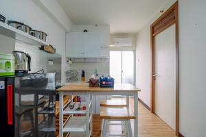 O bucătărie sau chicinetă la Comfortable and Tidy 2BR at Cinere Resort Apartment By Travelio
