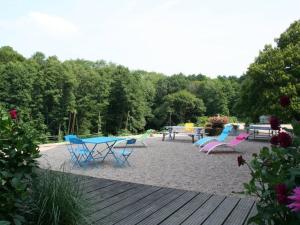 a group of picnic tables and chairs on a beach at Chambre Rubis: Élégance et Confort en Pleine Nature - FR-1-589-723 in Le Clerjus +5 photos