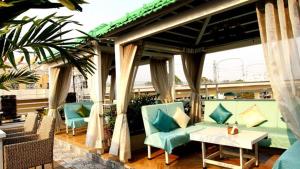 a patio with blue chairs and a table on a balcony at RSVP Nagpur in Nagpur