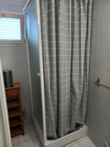 a shower with a shower curtain in a bathroom at L'Hermitage in Auxi-le-Château