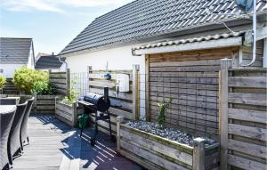 a backyard with a wooden fence and a solarium at Three-Bedroom Holiday Home In Ystad in Ystad +20 photos