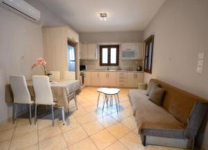 a living room with a couch and a table at Serenity Haven in Kalymnos
