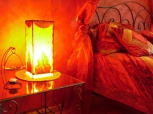 a bedroom with a bed and a table with a lamp at Maison charmante avec 4 chambres thématiques au cœur du pays de Jeanne d'Arc - FR-1-585-149 in Montigny-lès-Vaucouleurs