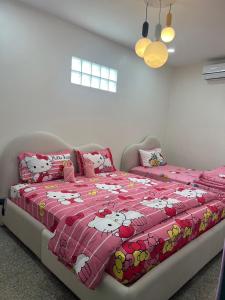 a bedroom with a bed with a hello kitty blanket at Pani House ( Hatyai 2 ) in Hat Yai +41 photos