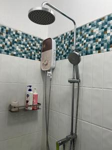 a bathroom with a shower with a phone on the wall at Pani House ( Hatyai 2 ) in Hat Yai