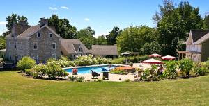 a large house with a swimming pool in a yard at Clyde Hall Bed and Breakfast in Lanark