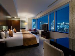 a hotel room with a bed and a view of a city at Hotel The Celestine Tokyo Shiba in Tokyo