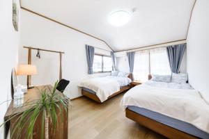 Postel nebo postele na pokoji v ubytování 東京芳华驿站