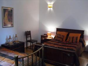 a bedroom with a bed and a desk and a chair at Détente à Montigny : 4 Chambres, Terrasse, Jardin - FR-1-585-154 in Montigny-lès-Vaucouleurs