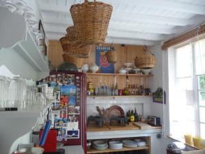 a kitchen with a refrigerator and baskets on the wall at Chambre spacieuse, entrée privée, animaux admis, WiFi - FR-1-590-513 in Presnoy +27 photos