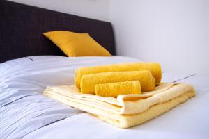 a pile of towels sitting on top of a bed at 29 Twyford in Eastleigh
