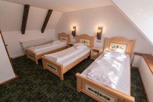 a room with two beds and two night stands at Rácz Kúria in Racoşu de Sus +67 photos