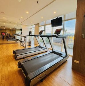 a gym with three treadmills in a room at LaFayette Park Square in Iloilo City