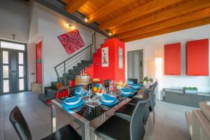 a dining room with a table and chairs and a staircase at Villa Laura Private Pool and Garden near Lake Maggiore for 9 - Happy Rentals in Besozzo