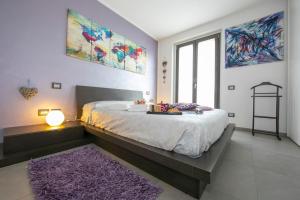 a bedroom with a large bed with a purple rug at Villa Laura Private Pool and Garden - Happy Rentals in Besozzo