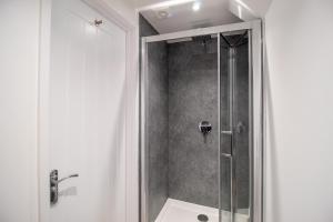 a shower with a glass door in a bathroom at 29 Twyford in Eastleigh