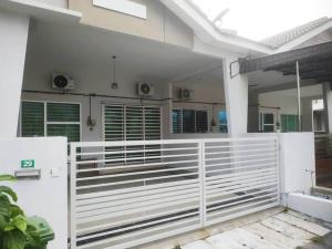 a white fence in front of a house at Setia Homestay Chemor Setia in Chemor