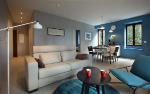 a living room with a couch and a table at Hotel des Eaux in Aix-les-Bains