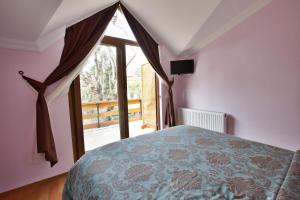 a bedroom with a bed and a large window at Nizam Butik Otel Büyükada in Buyukada