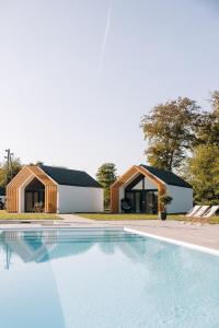 a swimming pool in front of two buildings at Wine Resort Mak in Maribor
