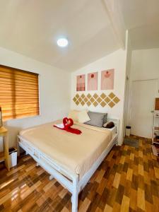 a bedroom with a bed with a red ribbon on it at S&E-3 Tiny Guest House - Olango Island in Lapu Lapu City