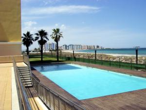 a swimming pool with a view of the beach at Beachfront penthouse in Residencial Dos Mares in La Manga del Mar Menor