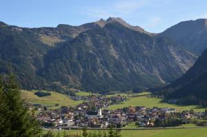 a small town in a valley in the mountains at Haus Sennweg in Tannheim