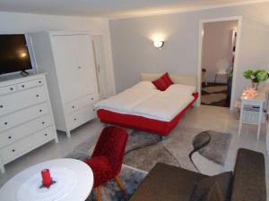 a bedroom with a bed and a table and chairs at Ferienwohnung Am Recknitzhang in Carlewitz +16 photos