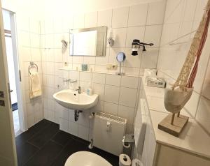 a small bathroom with a toilet and a sink at Binzer Sterne 23 Typ B , ID BS123 in Binz +18 photos