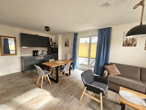 a living room with a couch and a table at Binzer Sterne 23 Typ B , ID BS123 in Binz