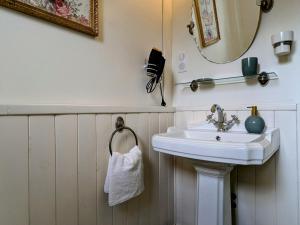 a bathroom with a sink and a mirror at Chambre Verte avec Jardin partagé près du Puy-en-Velay - FR-1-582-498 in Rosières +7 photos