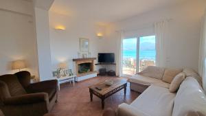 A television and/or entertainment centre at Alekos Beach Houses-Alekos Beach Complex