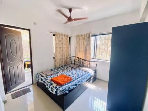 a bedroom with a bed and a ceiling fan at 2 BHK Luxury Apartment in Thivim Goa in Tivim