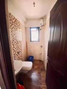 a small bathroom with a toilet and a sink at 2 BHK Luxury Apartment in Thivim Goa in Tivim