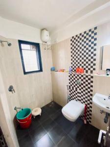 a small bathroom with a toilet and a sink at 2 BHK Luxury Apartment in Thivim Goa in Tivim +3 photos
