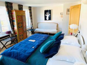 Un dormitorio con dos camas con almohadas azules. en La villa du Bau Reddoun ,piscine ,jardin , jolie vue sur Callian, calme et serenite, en Montauroux