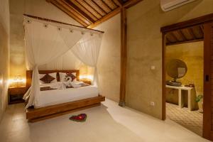 a bedroom with a canopy bed and a mirror at Pucuk Ubud Villa in Ubud +66 photos