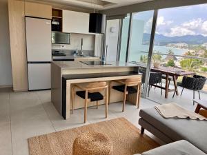 a kitchen and dining room with a view of the ocean at Rooftop Pool Suites Vallarta in Bucerías
