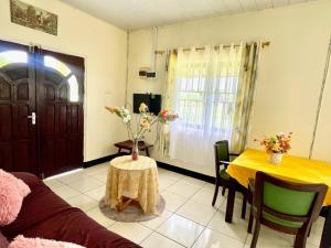 a living room with a couch and a table at 3 Bed House - Sleeps 6 - Garden - Parking - Wifi in Paramaribo