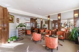 a restaurant with orange chairs and tables in a room at Noviz Hotel in Plovdiv +181 photos