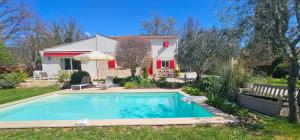 a house with a swimming pool in the yard at Chambre d'Hôtes "Au Clos des Redonnets" avec Piscine in Saint-Cézaire-sur-Siagne