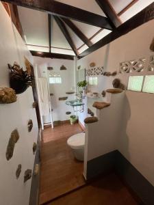 a bathroom with a toilet and some rocks on the wall at Oon Lee Bungalows in Ko Jum +37 photos