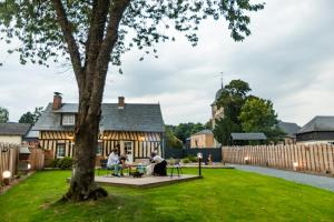 people sitting around a table in the yard of a house at Gîte Saint Amour in Le Pin